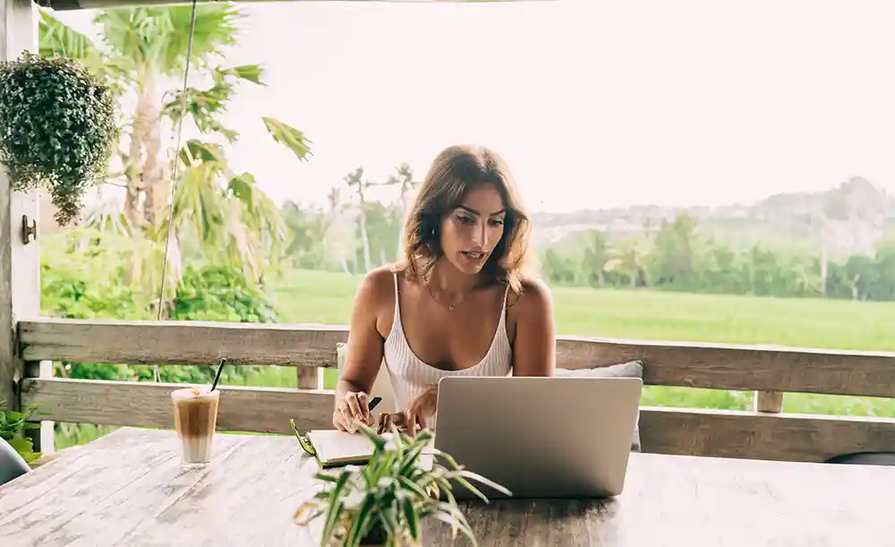 woman working on beautiful terrace while on bleisure trip
